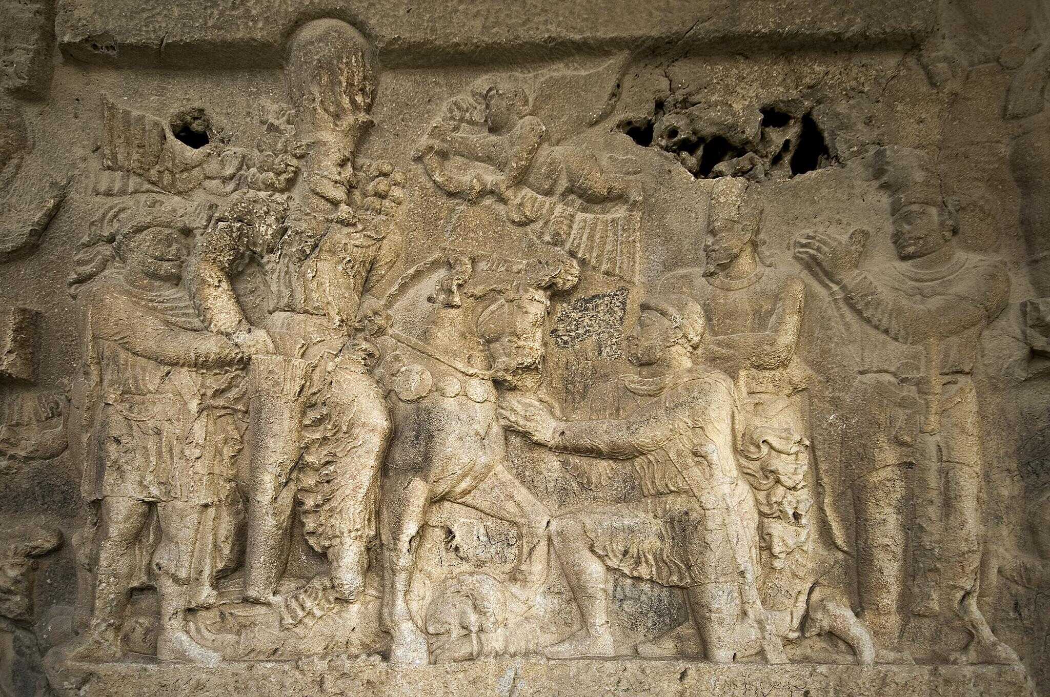A Bishapur Bas-Relief that shows Roman Emperor Gordian III defeated and trampled under Shapur's horse, while Shapur has Valerian by the hand to underline Valerian's slavehood
