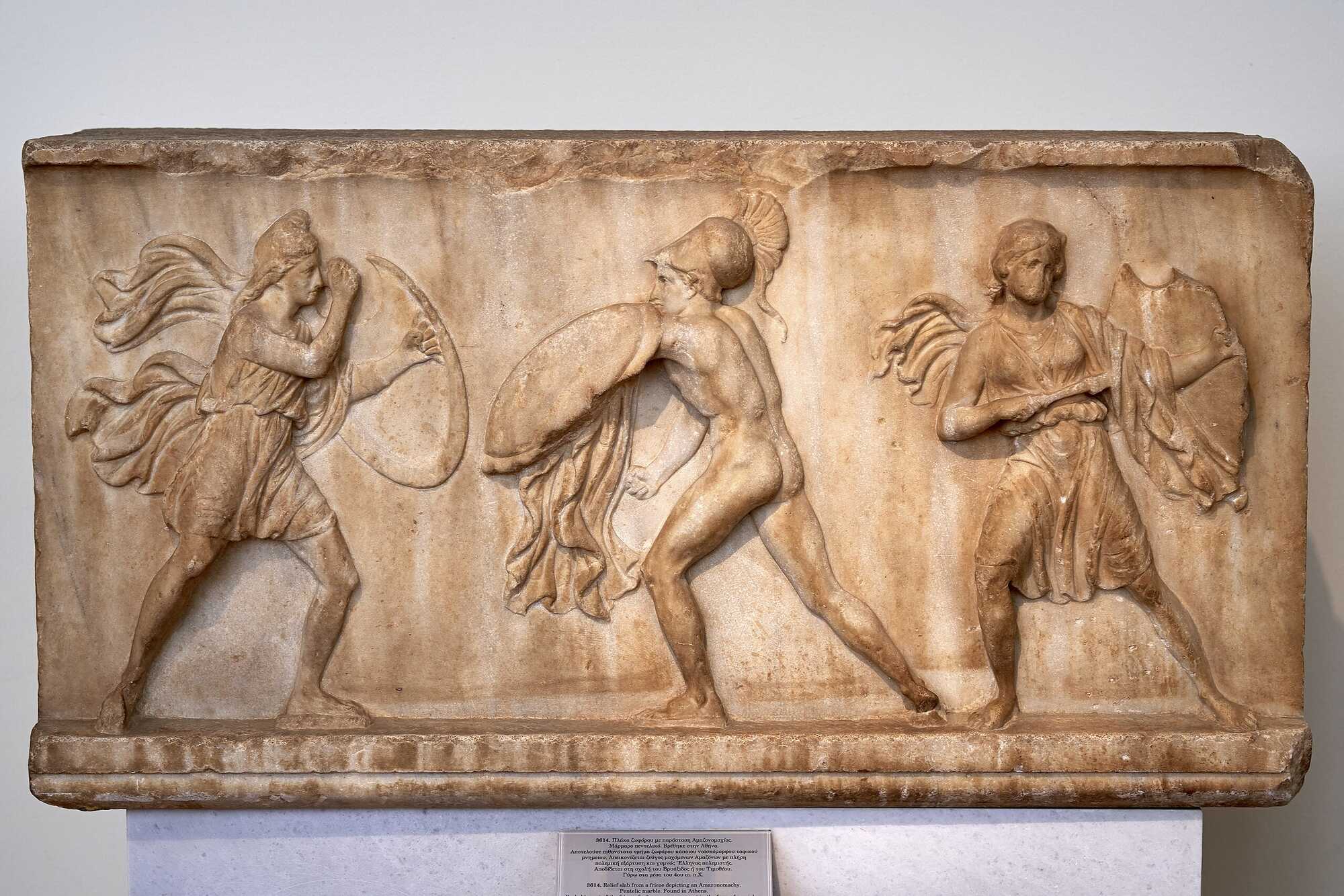 Relief Pentelic marble slab from a frieze found in Athens, depicting an Amazonomachy between two Amazons with full military equipment, and a nude Greek warrior