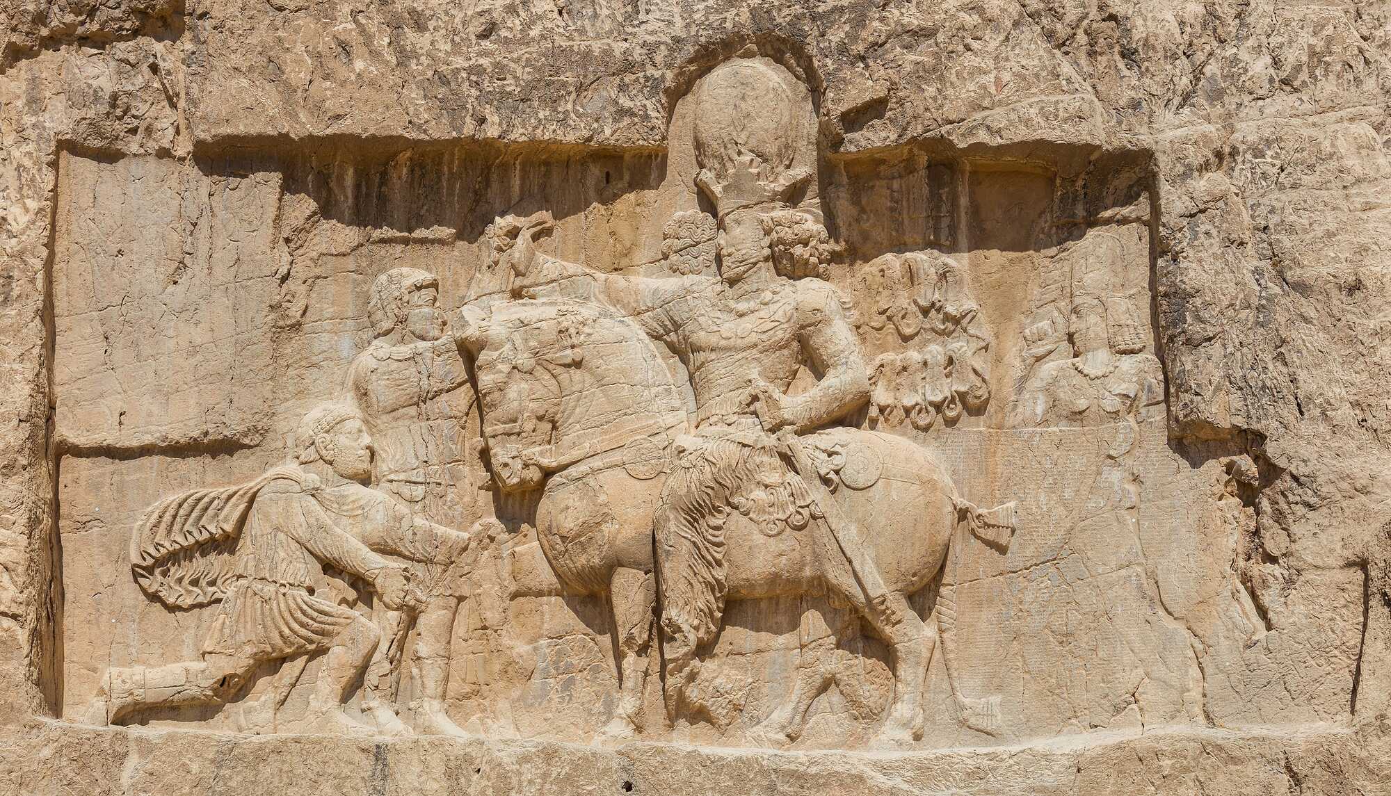 Relief of triumph of Shapur I over Valerian at Naqsh-e Rostam depicting a famous scene in which the Roman Emperor, Valerian, is kneeling before Shapur I and asking for mercy
