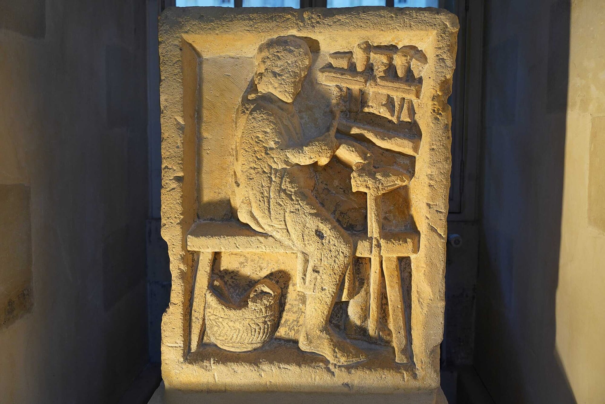 Stone relief of a Roman cobbler