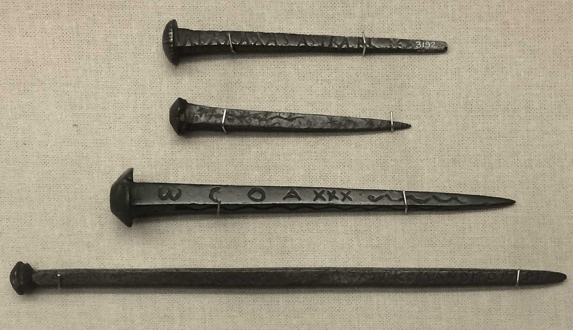 Roman magical nails 'fixed' permanently with the power of magic, some were used in shrines, others were probably driven into doors of houses to protect the household, the largest nail here has an incantation to the goddess Aremis