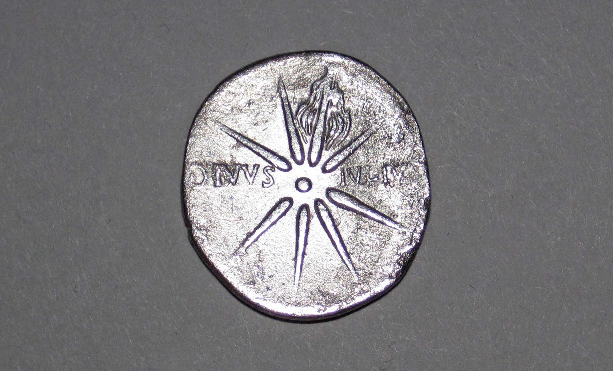 This is the reverse side of a ~2040 year old, one denarius silver Roman coin depicting the Comet Caesar, the most famous and daytime-visible comet in history, which appeared in the summer of 44 BC