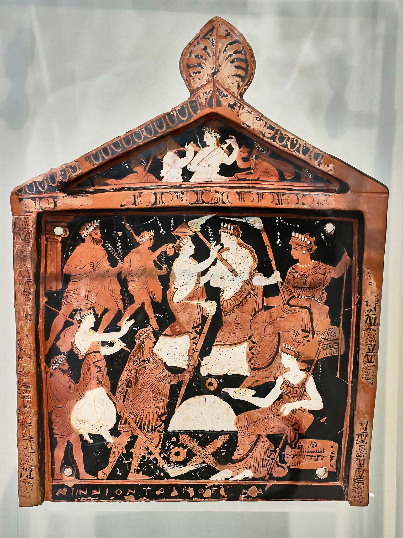 Terracotta votive plaque dedicated by Niinion to the two great goddesses of Eleusis, as indicated by the inscription on the lower part and the representations