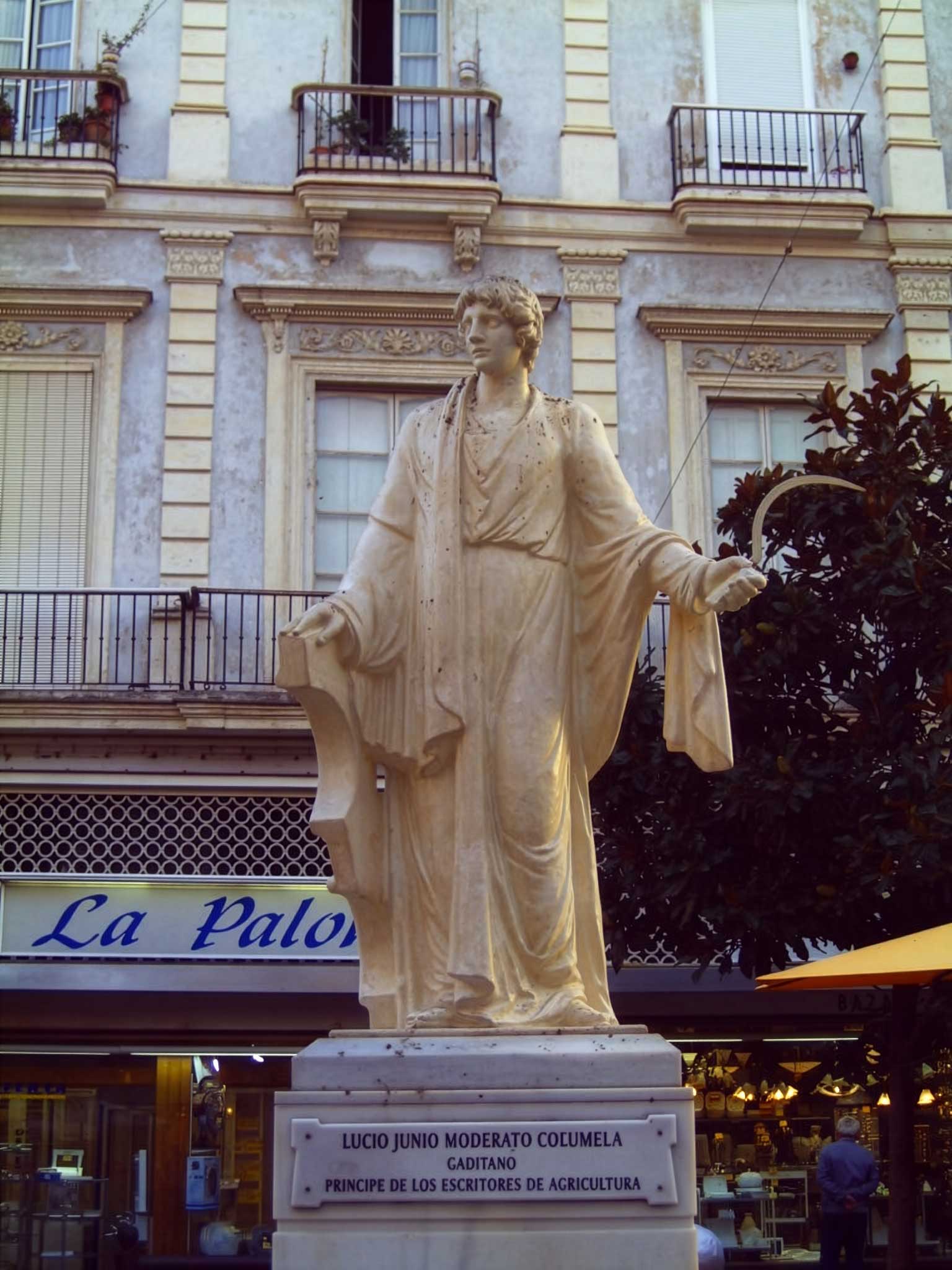 Statue of Columella, holding a sickle and an ox-yoke, in the Plaza de las Flores, Cádiz