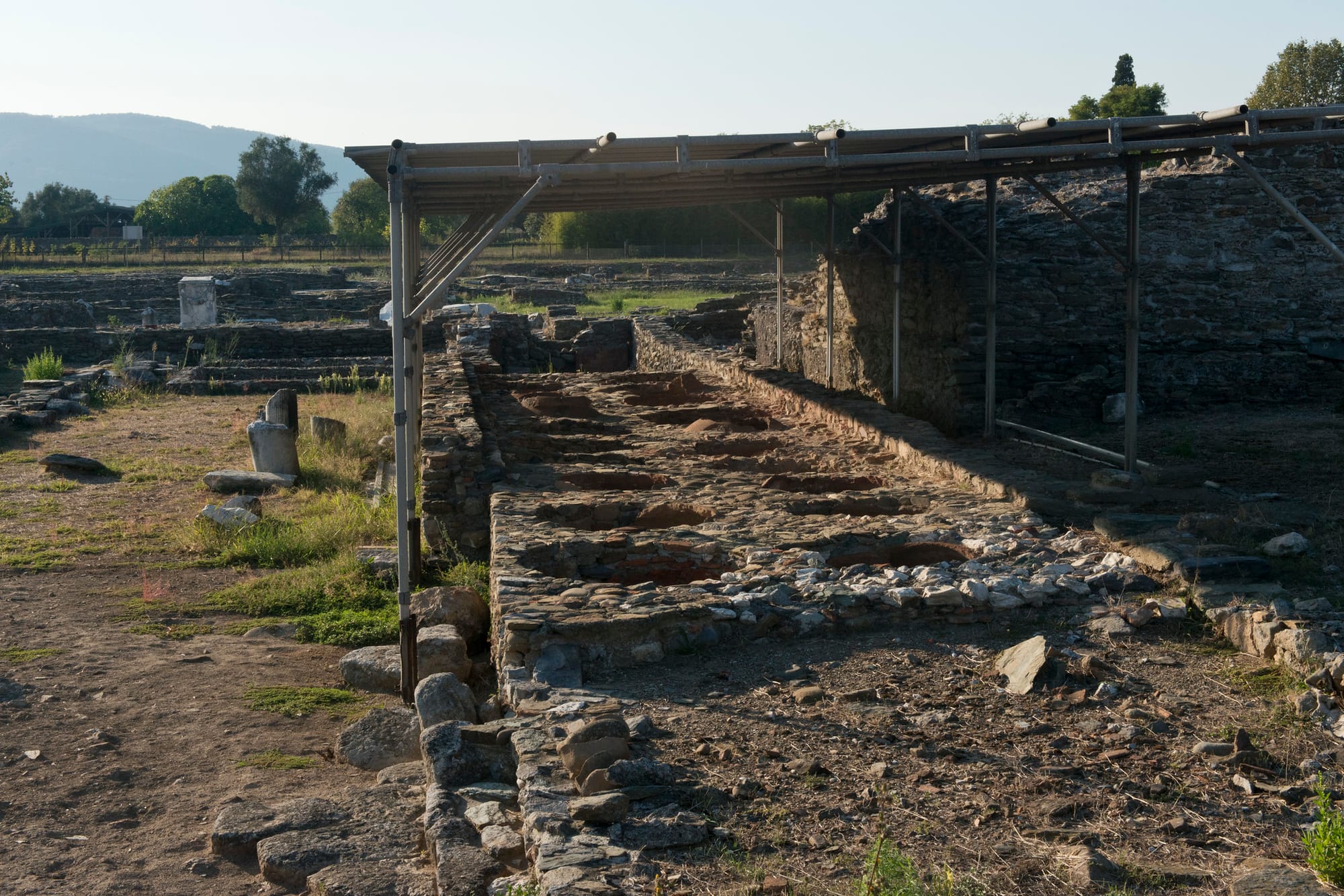  A warehouse with 20 dolia defossa (buried jars) for storing wine or olive-oil was built on the decumanus minor, near the temple of Diana