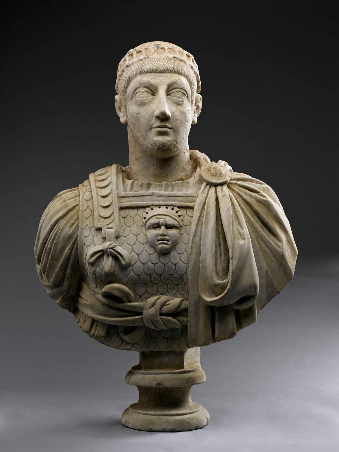 Bust of Valentinian III set in a modern bust in the Louvre.