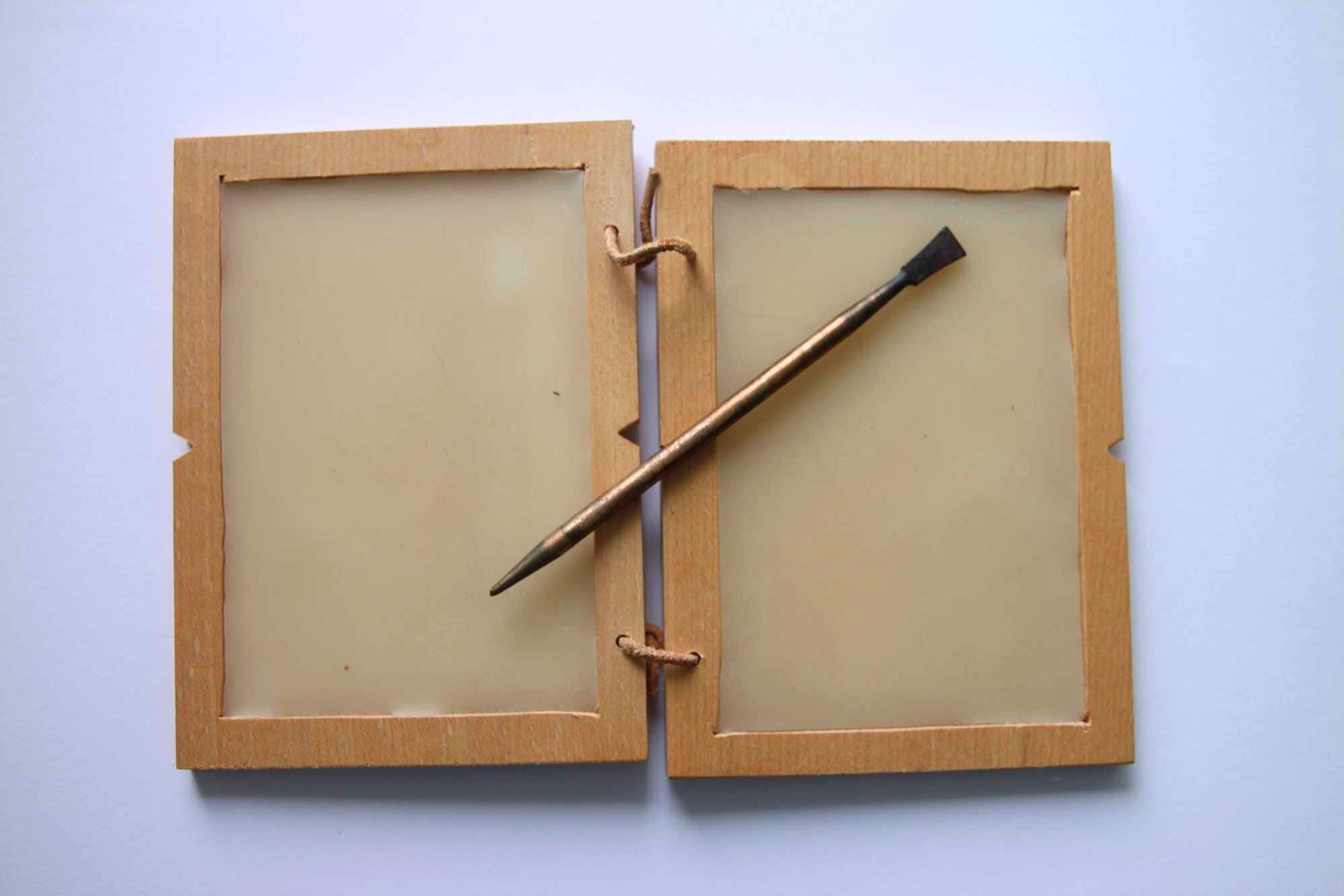 Writing tablet with wax and stylus. Roman period. The sharp tip was used for writing and the flat end was for wiping it out.