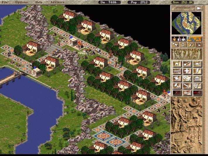 An isometric Roman town with houses, roads, trees and waterfront buildings in Caesar III.
