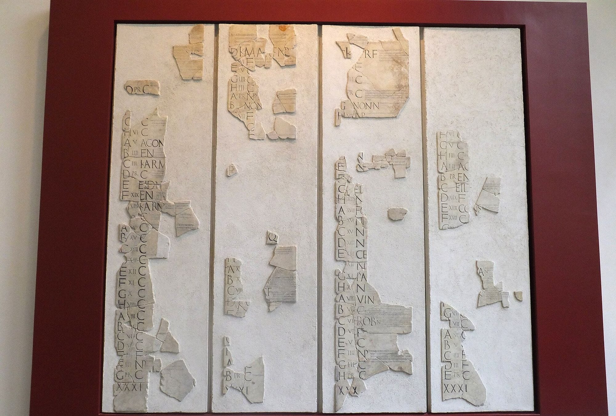 Reassembled marble fragments of the Fasti Praenestini display columns of Roman calendar inscriptions.