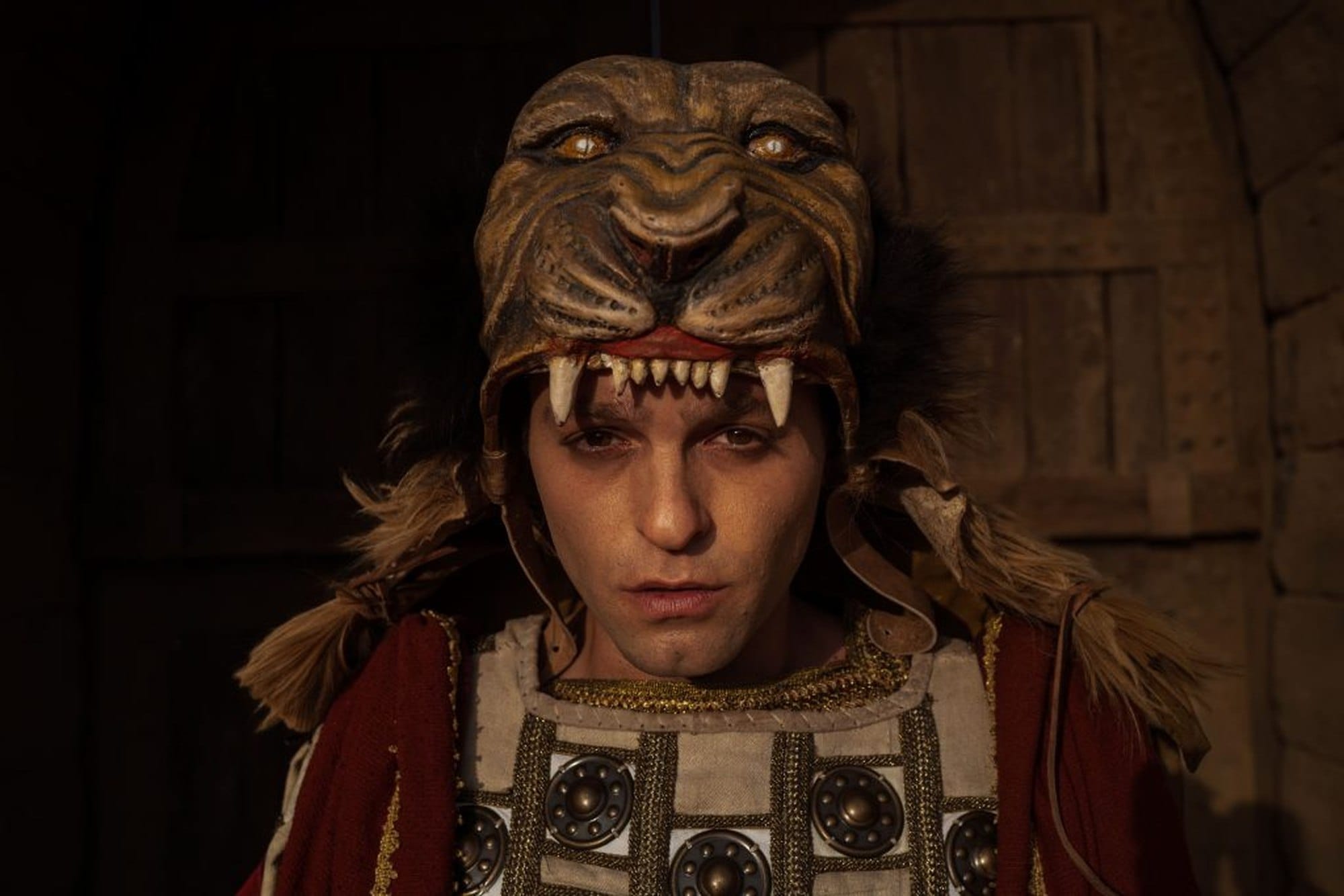 Costumed performer wearing an animal headdress in Colosseum.