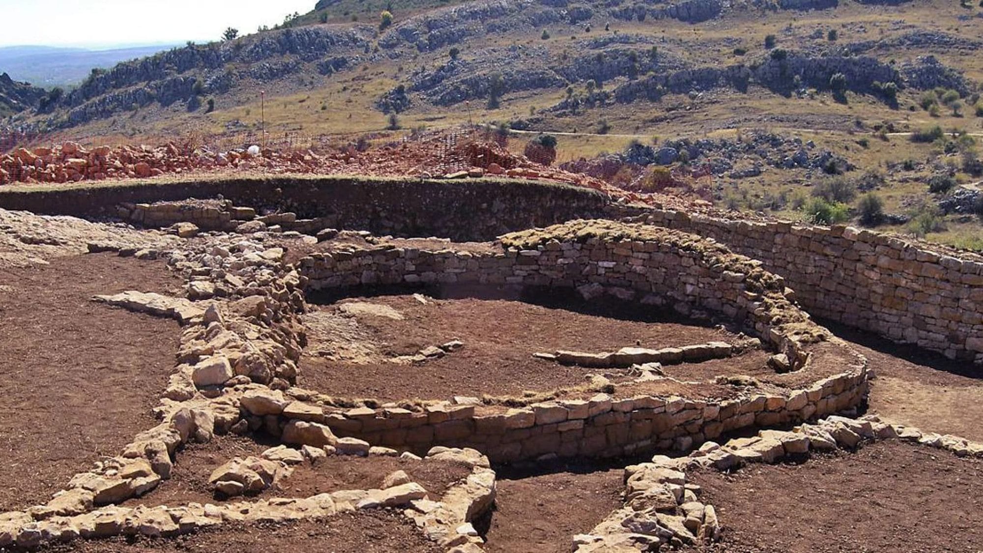 Curved stone walls and internal divisions of an excavated D-shaped Iron Age temple at La Peña del Castro.