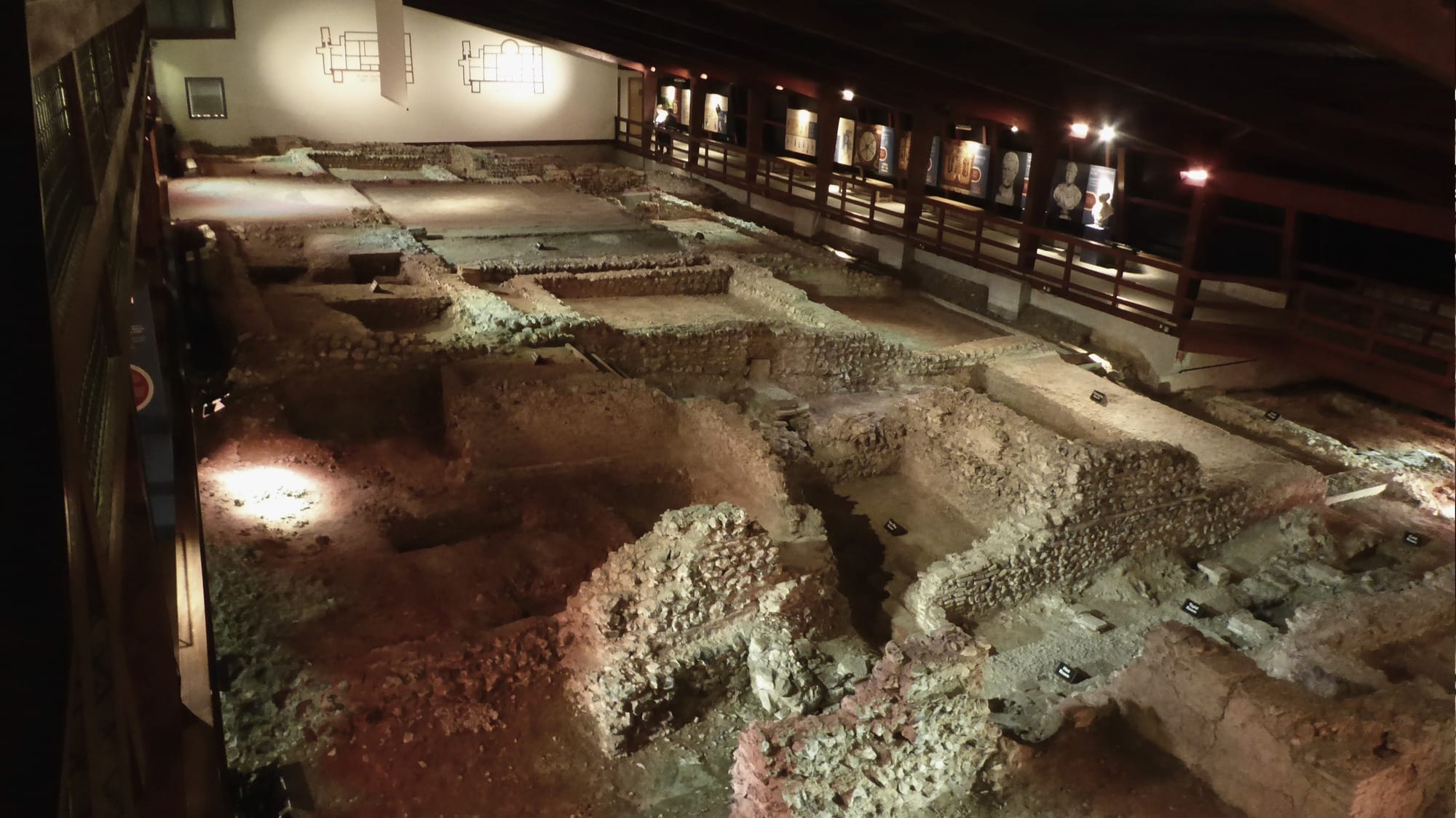 Excavated stone walls and rooms of Lullingstone Roman Villa inside its protective building in Kent.