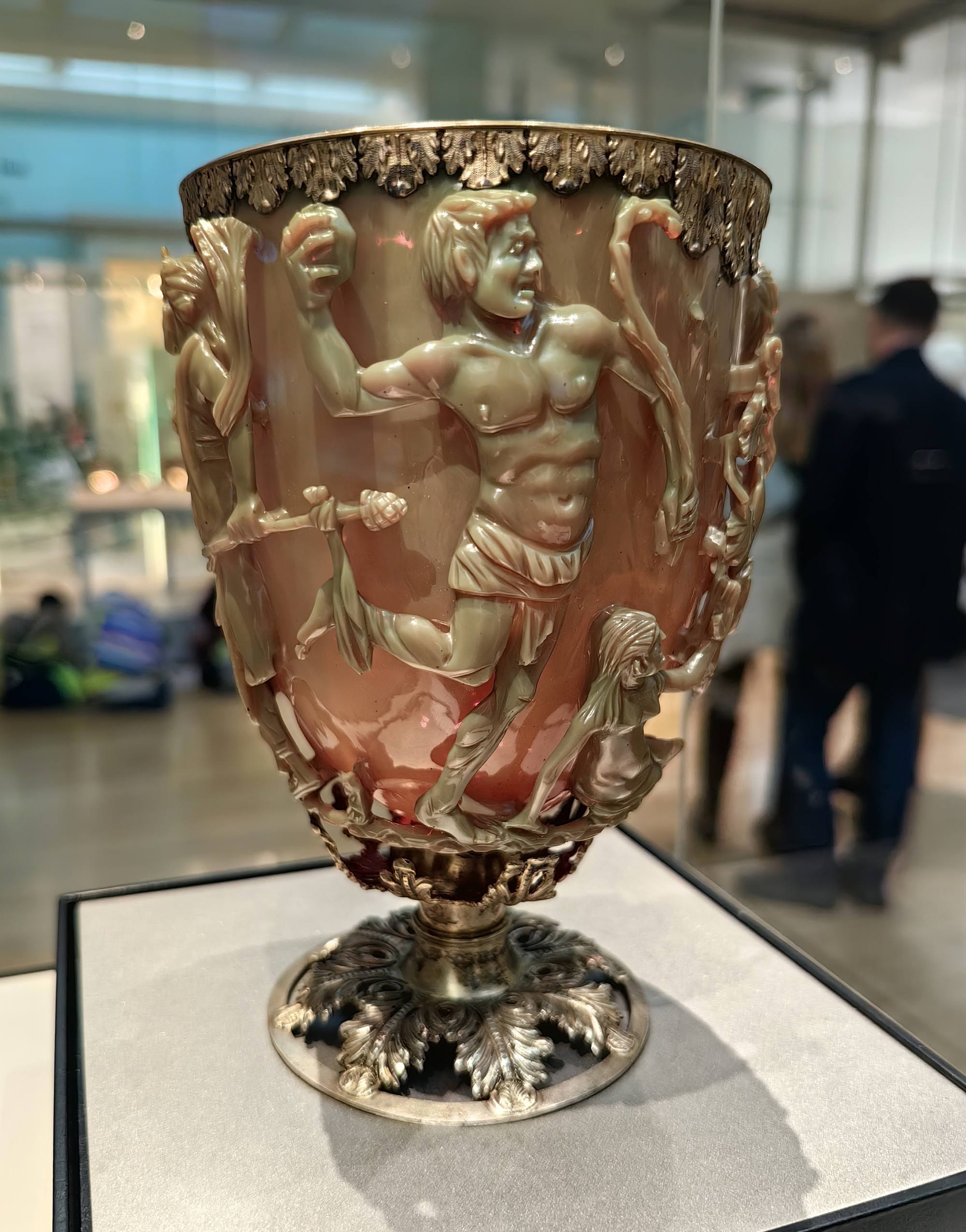 Full view of the Lycurgus Cup, showing Lycurgus entangled in carved vines above its metal foot.