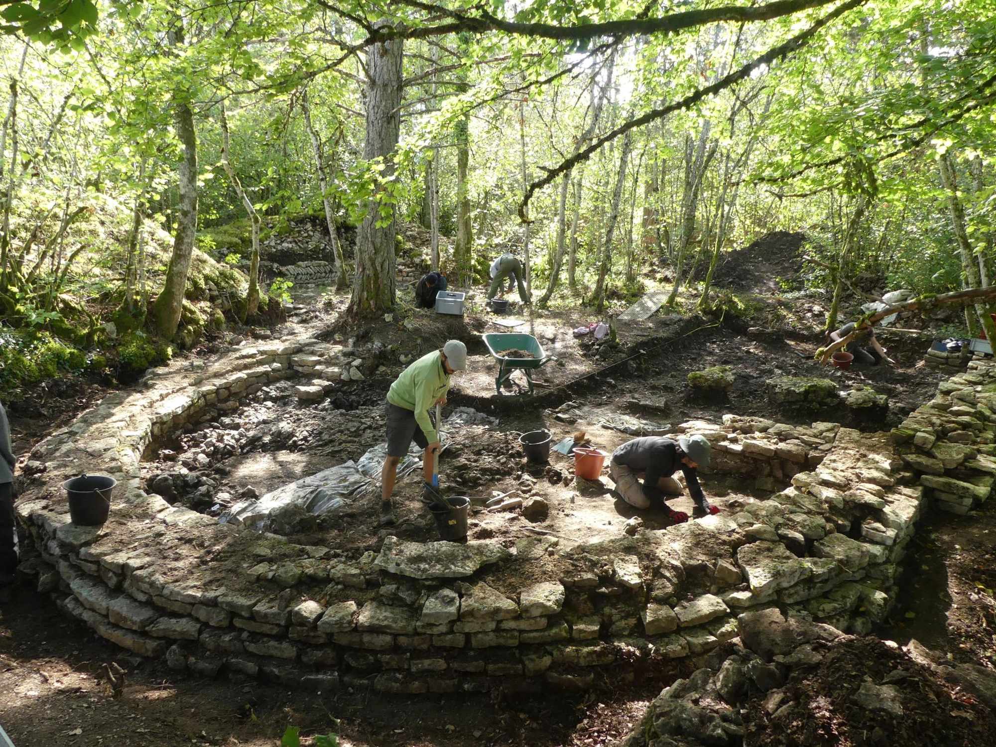 Archaeologists excavate the stone apse and choir of the summit church at Mesmont in 2022.