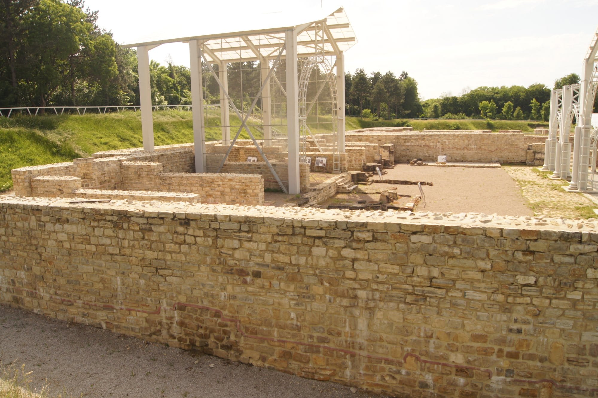 Excavated walls of the legionary headquarters at Novae, Bulgaria, beneath modern protective structures.