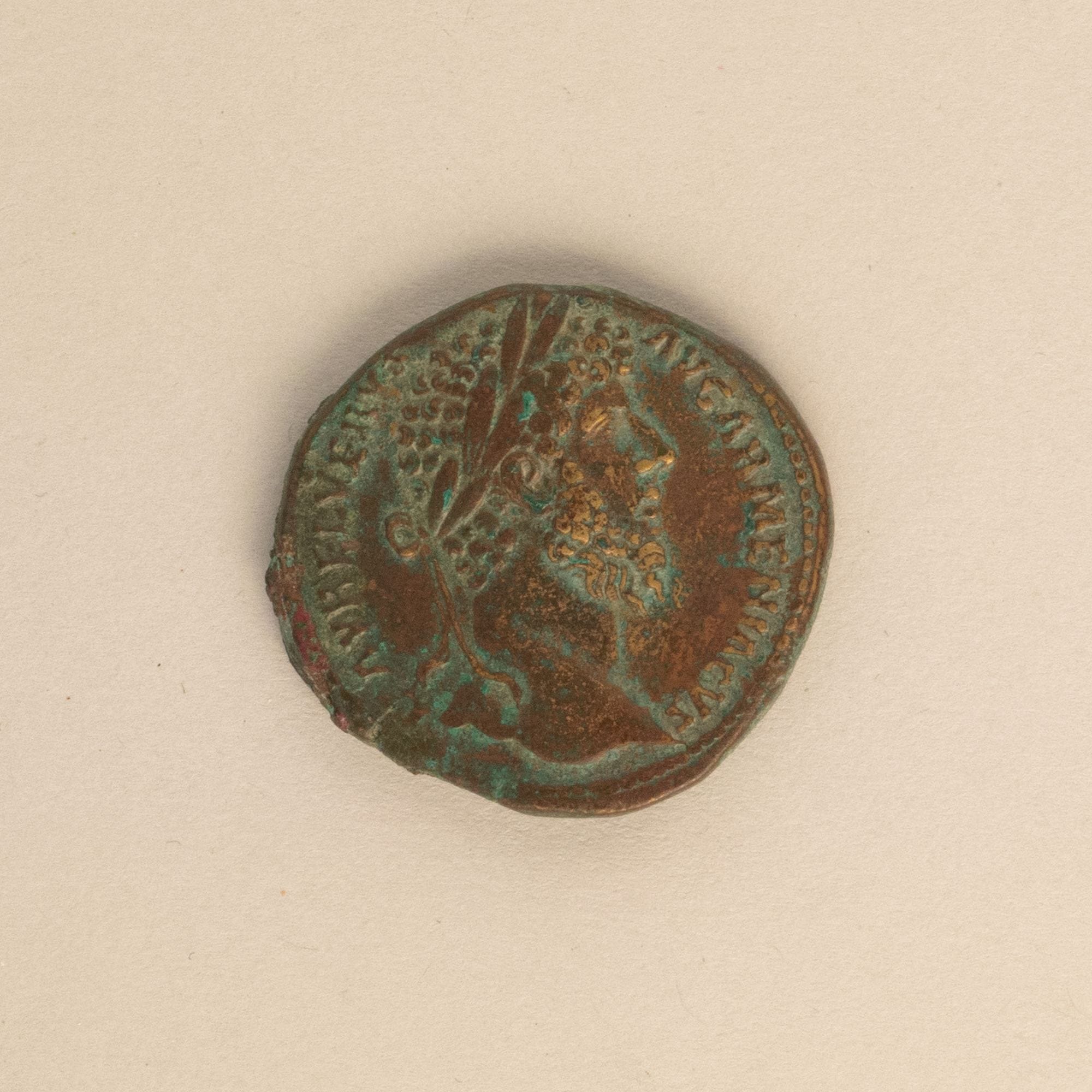 Obverse of a patinated bronze sestertius showing the bearded head and surrounding inscription of Lucius Verus.