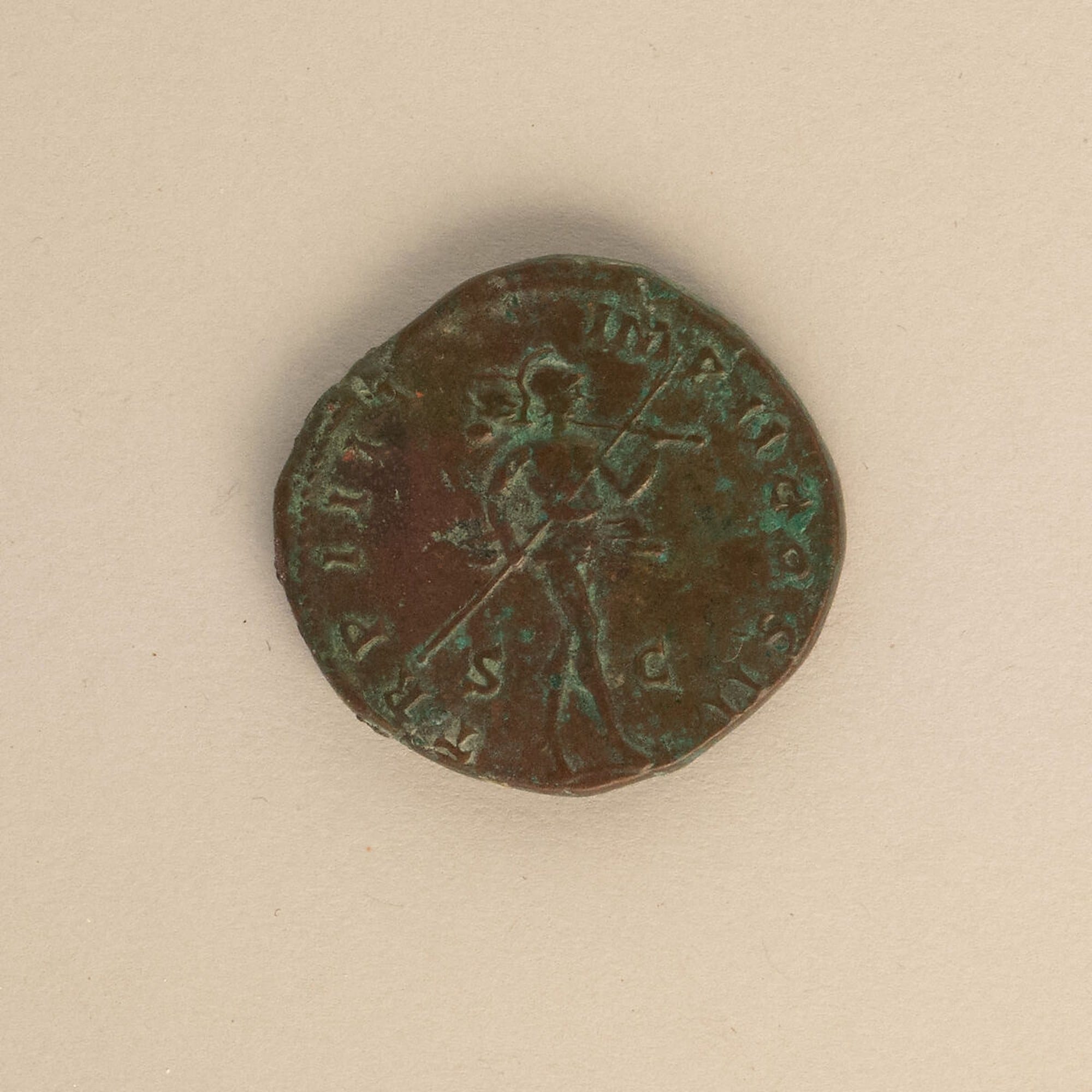 Reverse of a bronze sestertius of Lucius Verus showing Mars standing with a spear and trophy amid abbreviated lettering.