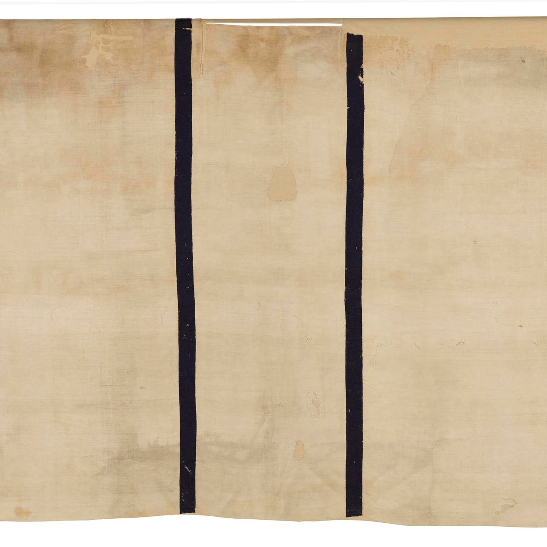 Roman-period Egyptian tunic with dark vertical bands on a light fabric.