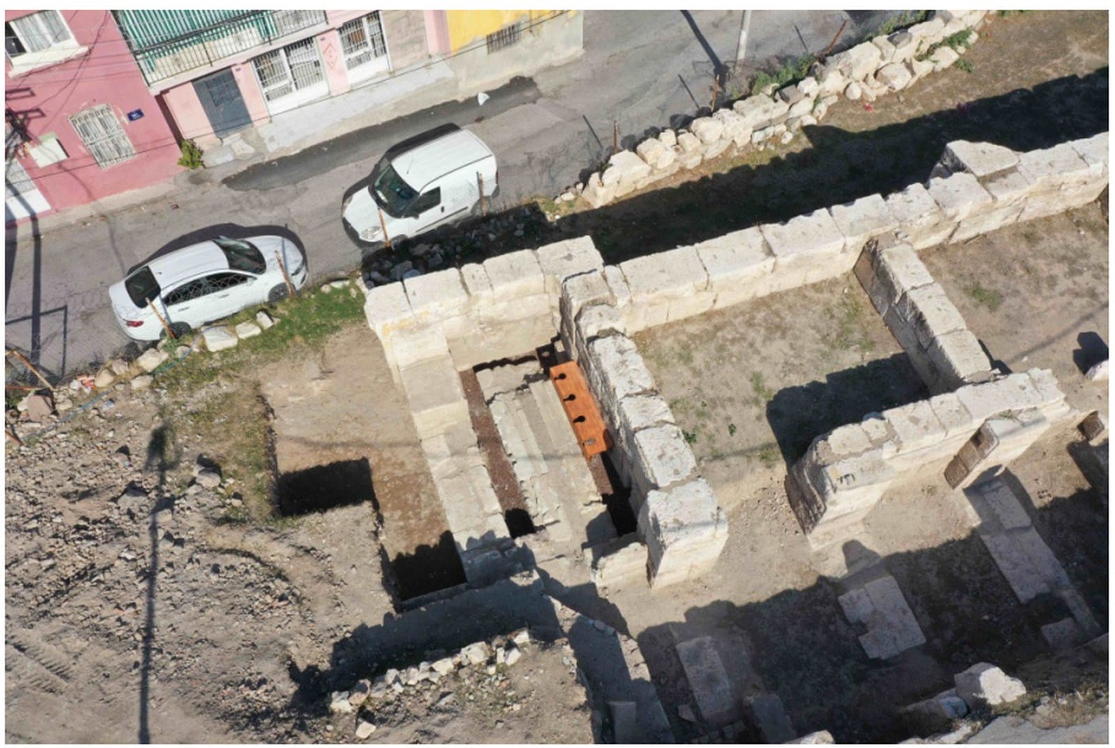 Excavated stone walls and latrine channel in a room of Smyrna’s theater stage building.