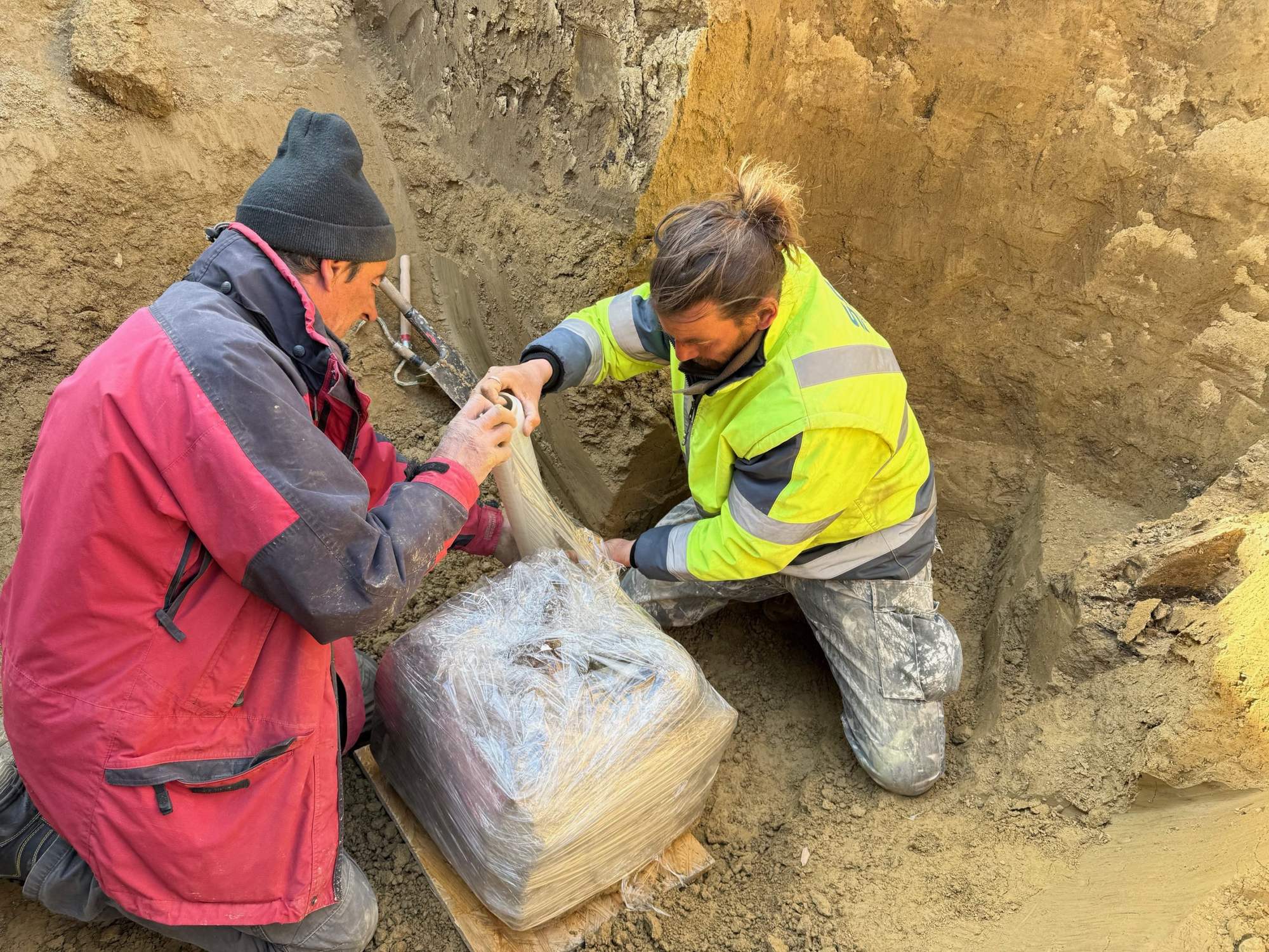 Soil blocks containing fragile archaeological finds being removed from the Šurany Roman camp for conservation.
