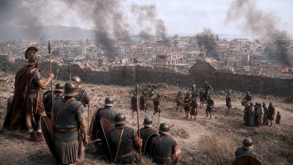 A photorealistic reconstruction of Roman soldiers overseeing a captured city as buildings burn and property is removed.