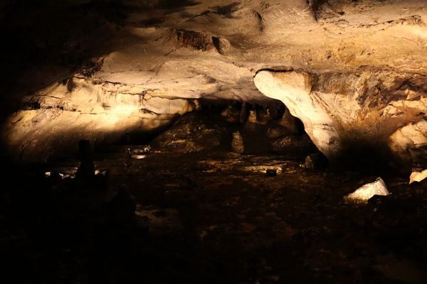 Rock formations and shallow water in the Roman sanctuary chamber at Cova Dones.