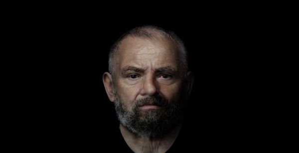 Digital reconstruction of an older bearded man from Roman Inveresk, shown against a black background.