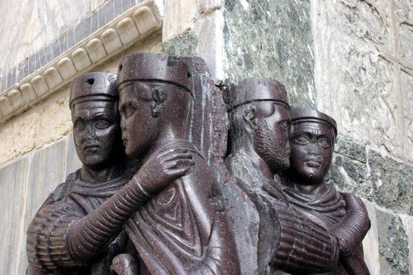 Four porphyry figures of Roman tetrarchs embracing, seen in close-up at St Mark’s Basilica in Venice.