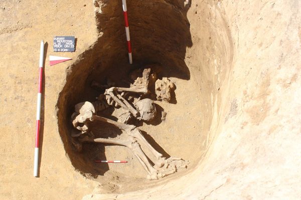 Excavated human skeleton in a deep pit at the Roman camp near Šurany, Slovakia, photographed during fieldwork.
