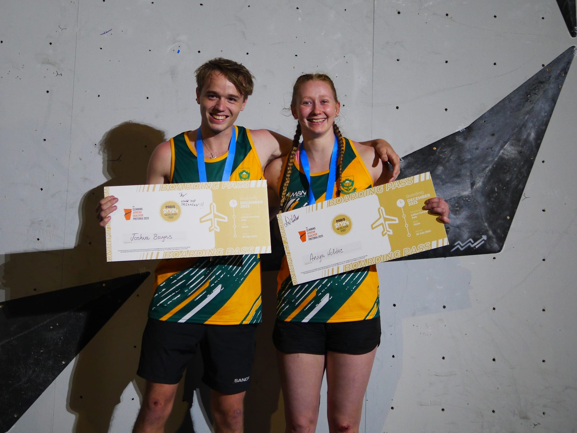 Aniya Holder and Joshua Bryuns posing with their Olympic tickets for Speed Climbing at Paris 2024