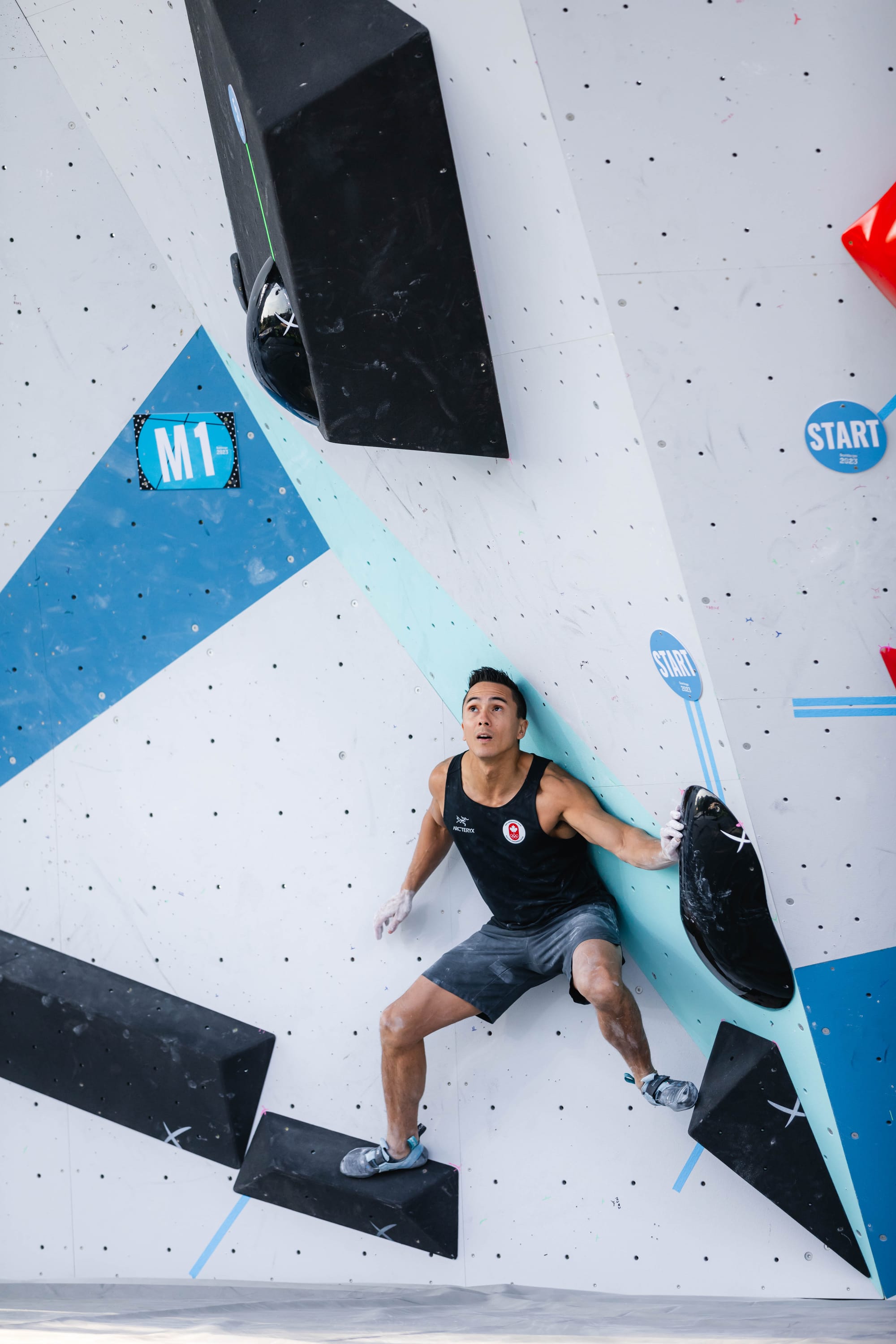 Sean McColl setting up for the first of three dynos on Boulder 1