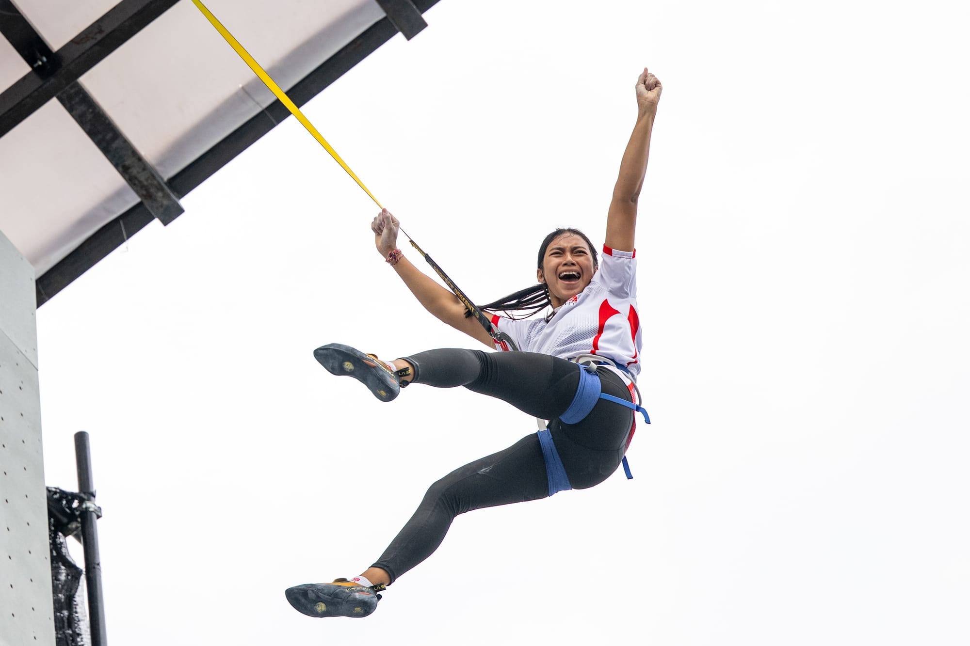 Kadek celebrates her bronze medal on the way down from the top of the wall.