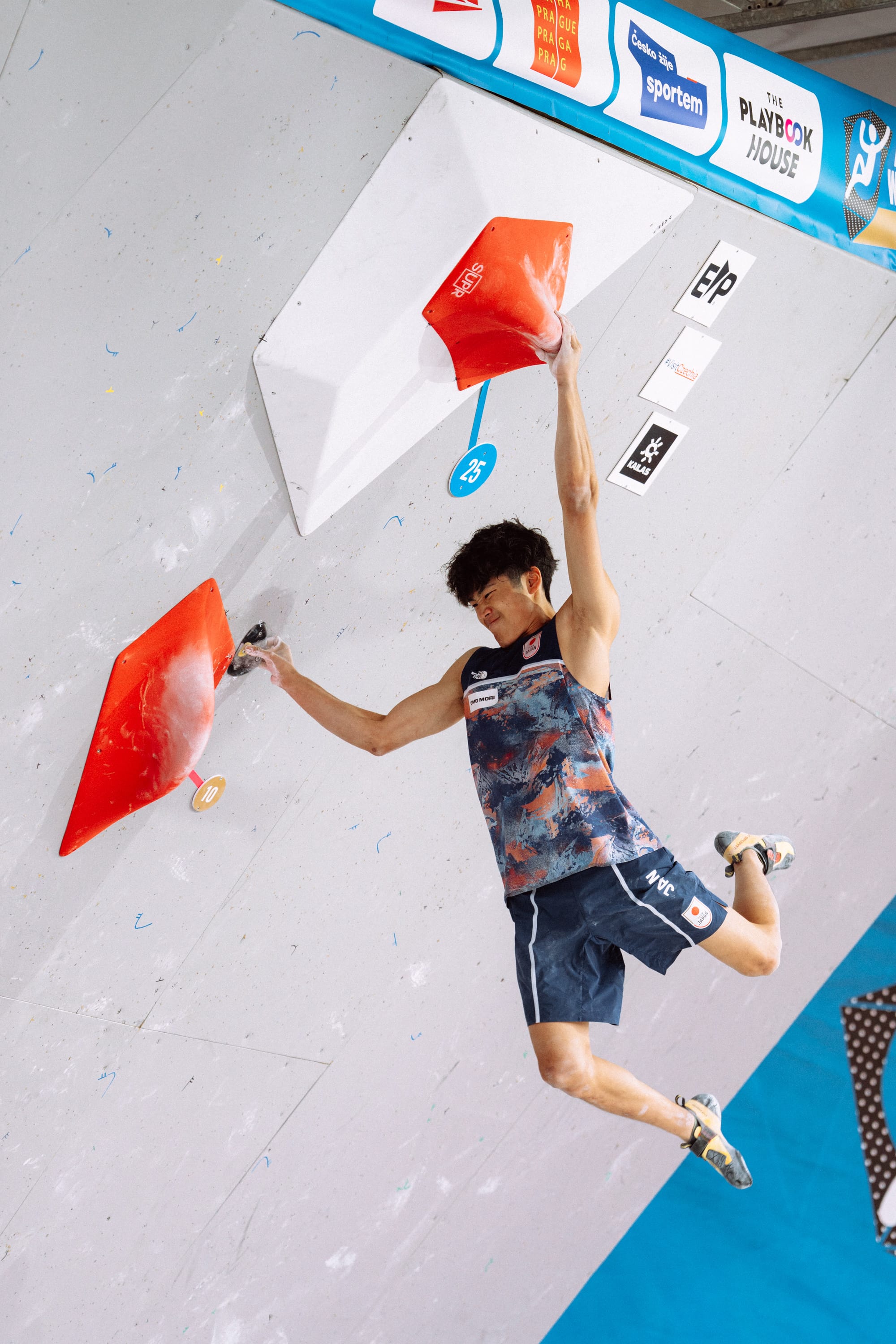 Sorato Anraku holding the top move of the first power boulder of the men's semi-final round.