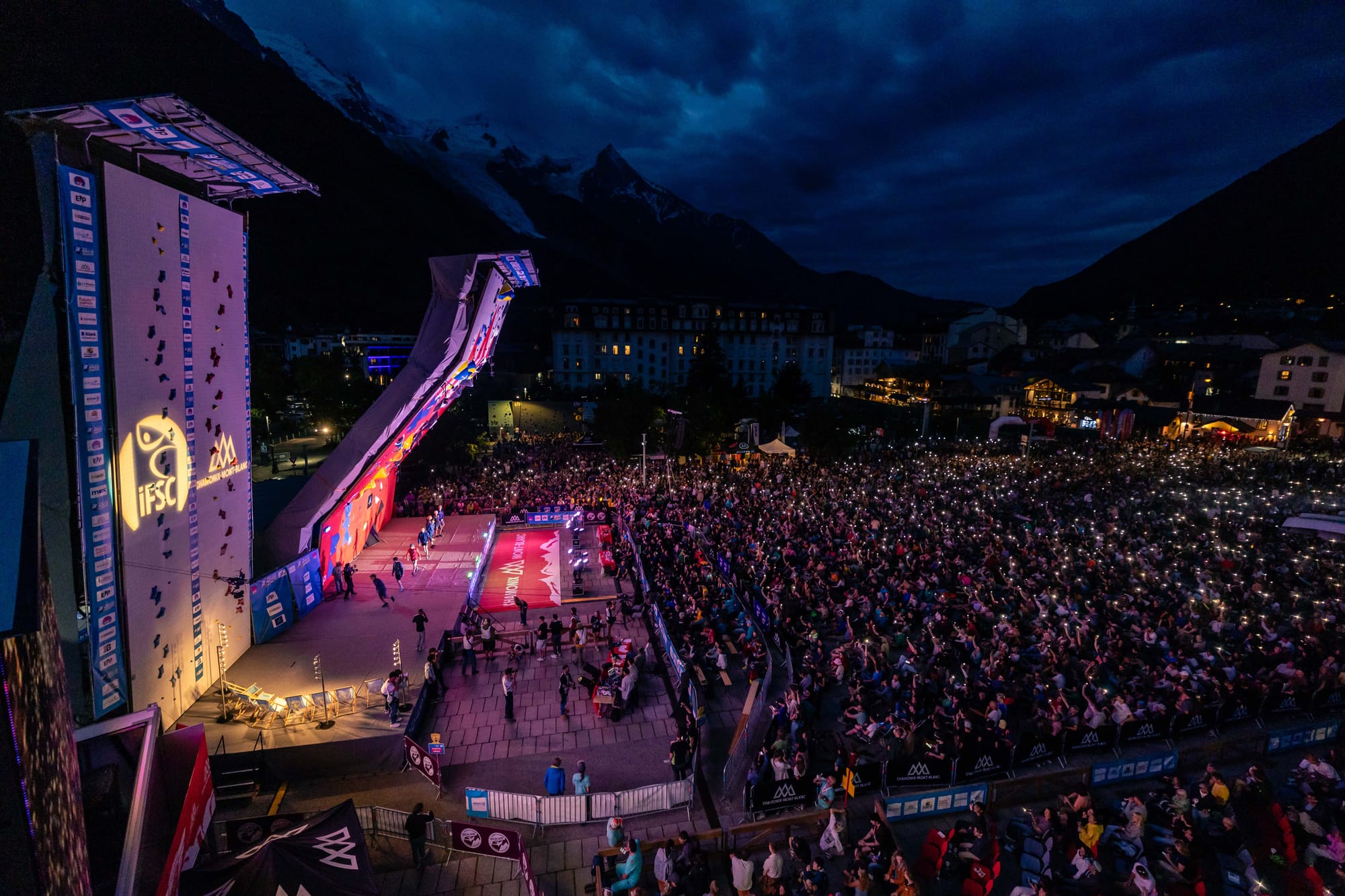 View of Chamonix 2024 crowd watching the World Cup with phones held up like candles