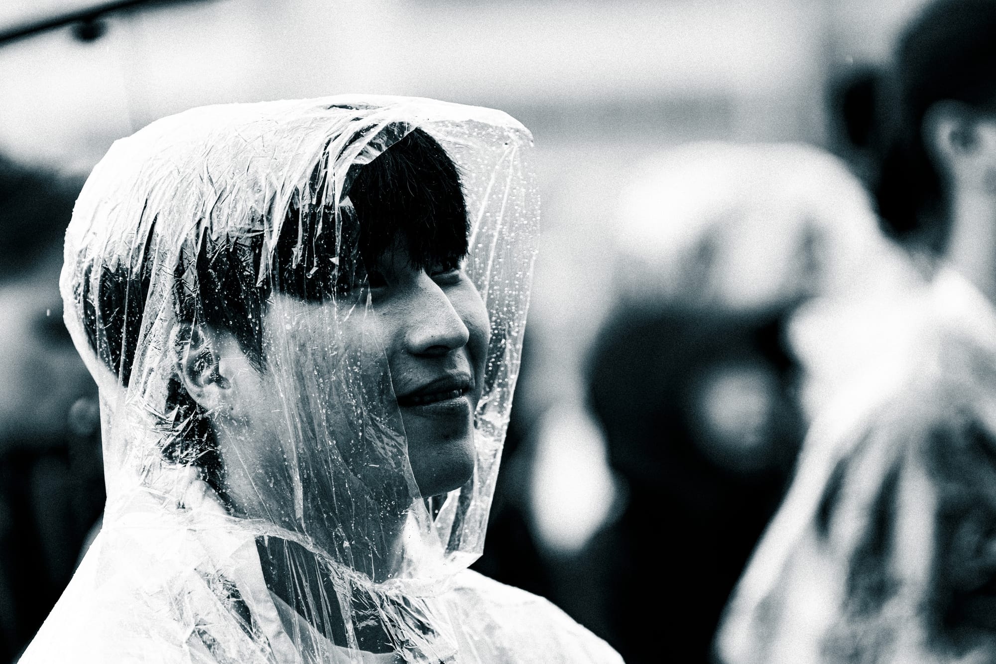 Dohyun Lee in a rain poncho at the Prague World Cup watching on
