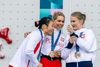 The Olympic medalists taking a selfie with their medals on the podium on the Samsung flip phone