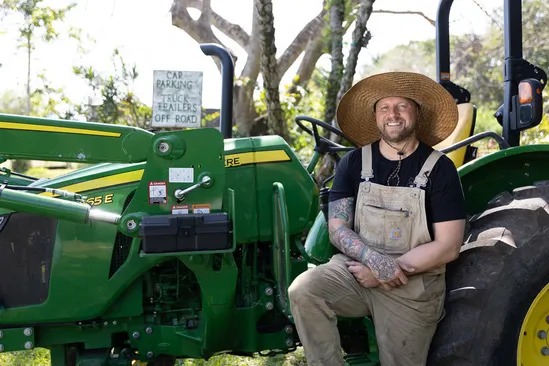 Chef Jeremy Ford on the farm tractor