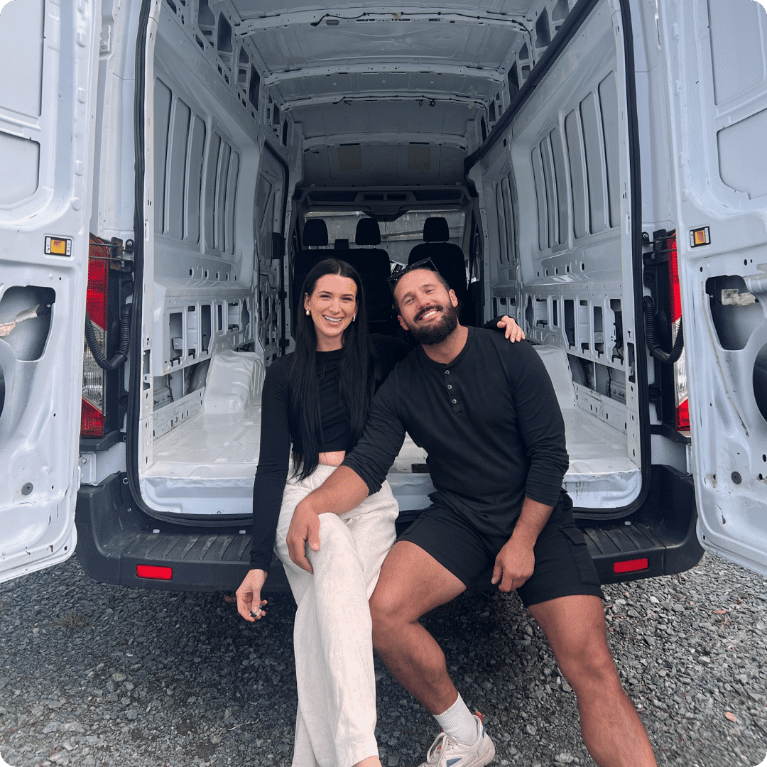 Couple sitting in the back of an empty panel van