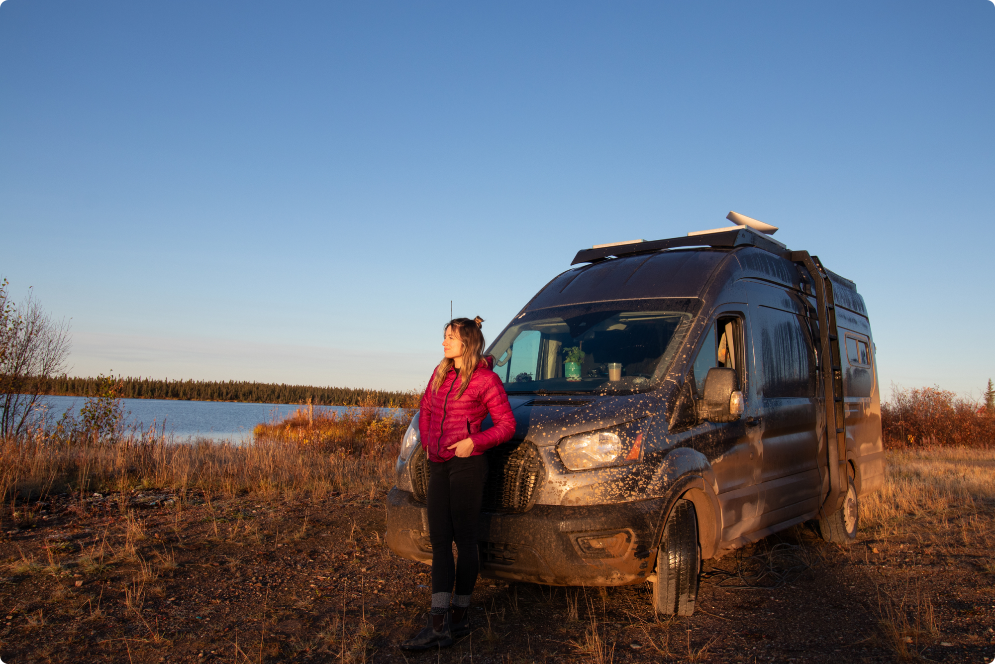 Woman standing in front of a muddy van