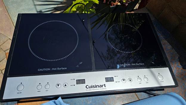A black and silver, dual induction burner