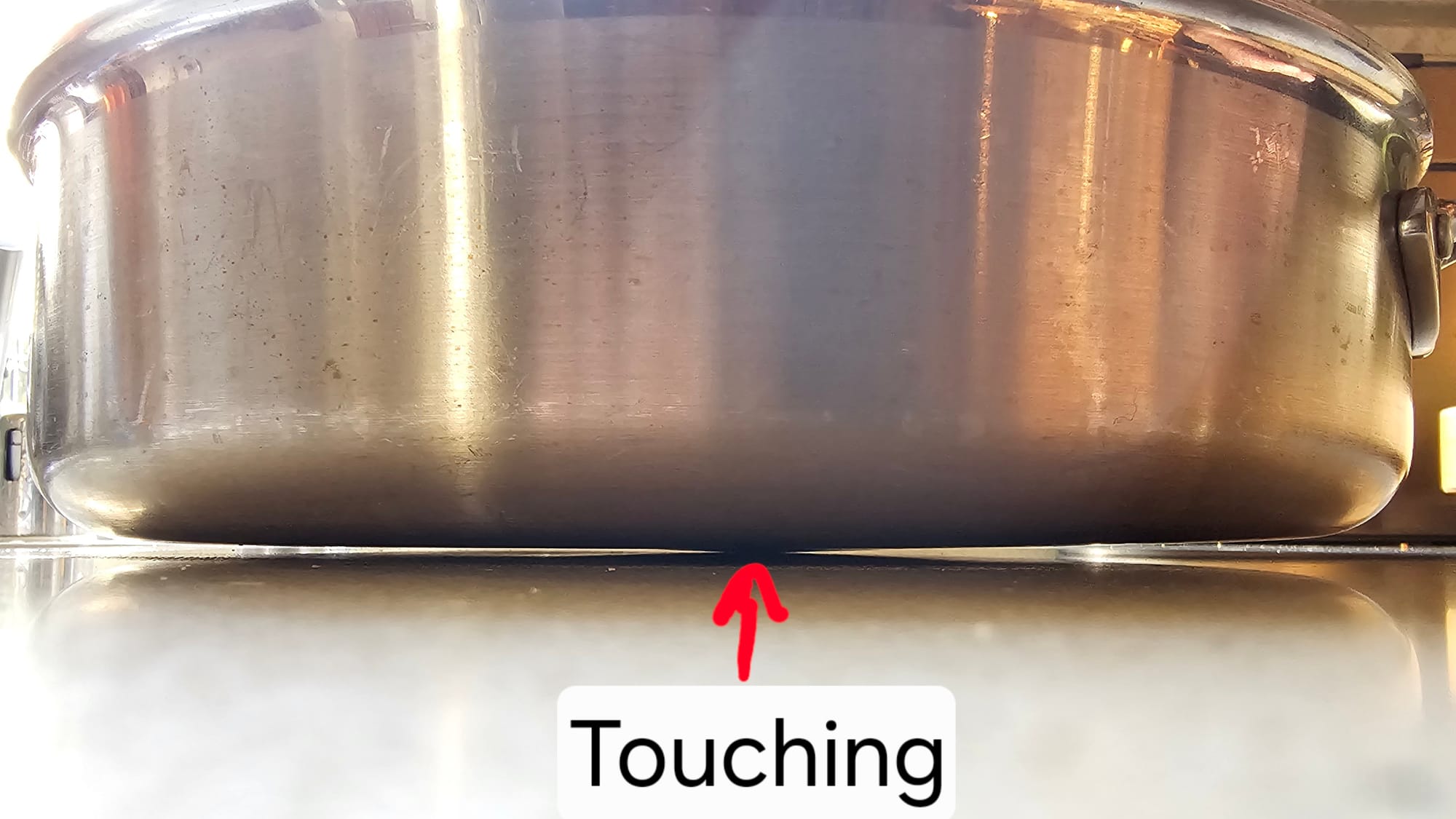 Pan sitting on a countertop with only the center touching.