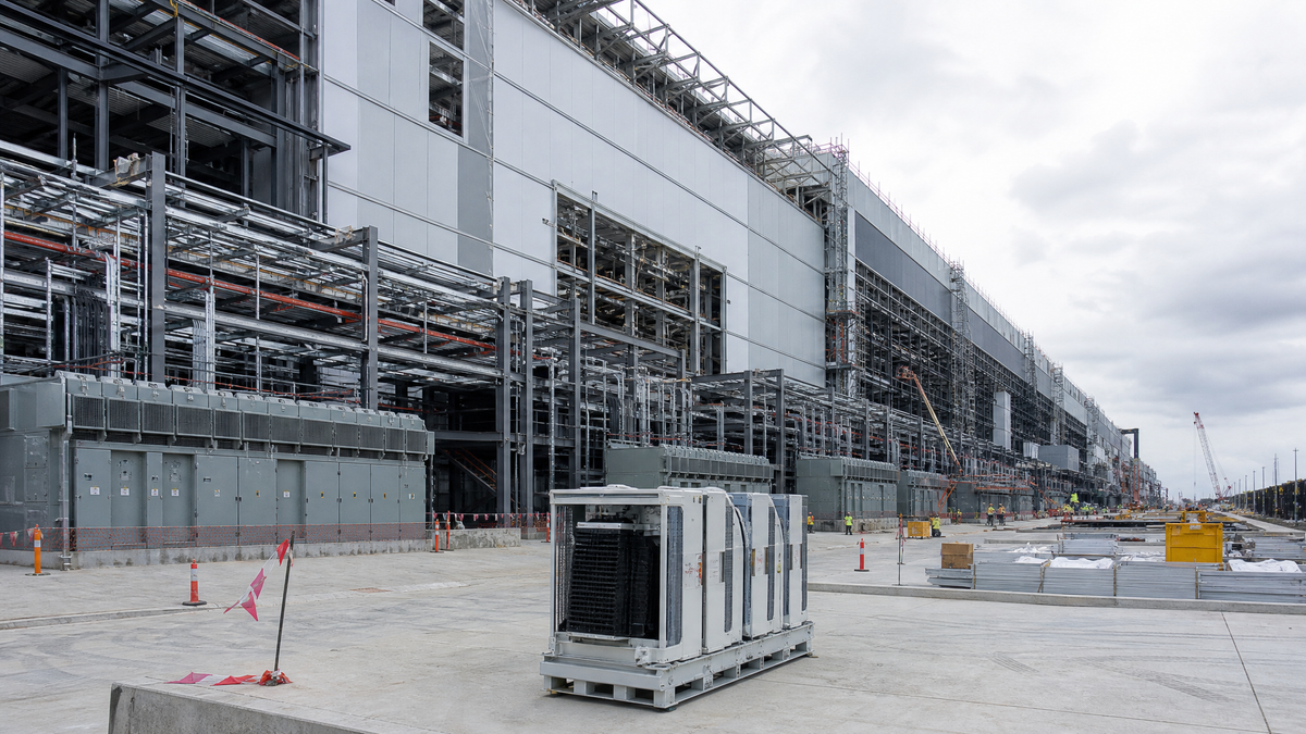 A large semiconductor fabrication site under construction, symbolizing vertical integration in the AI chip manufacturing stack