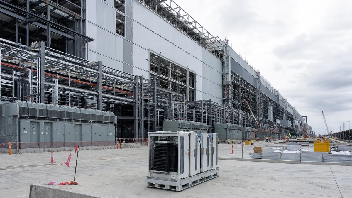 A large semiconductor fabrication site under construction, symbolizing vertical integration in the AI chip manufacturing stack