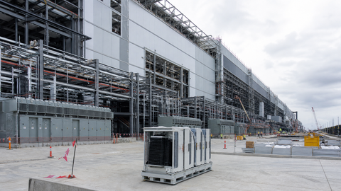 A large semiconductor fabrication site under construction, symbolizing vertical integration in the AI chip manufacturing stack