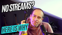Frenck in a hoodie at his desk, earbuds in, holding a small camera; podcast mic in frame. On-screen text reads: NO STREAMS? HERE IS WHY.