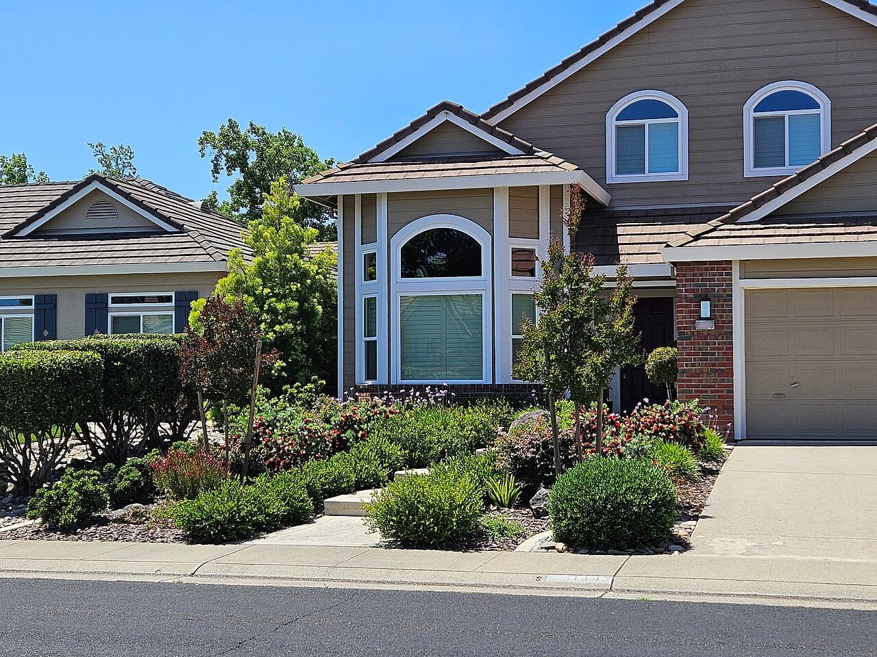 Front yard with clean mulched planting beds that look intentional while plants grow in