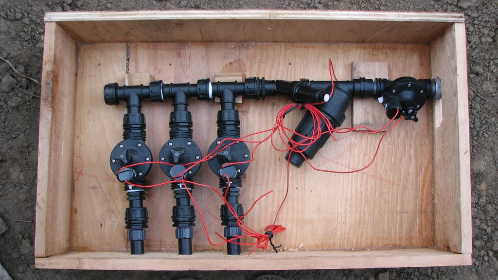 Drip irrigation head assembly with valves, Y-filter and pressure regulator mounted on a board