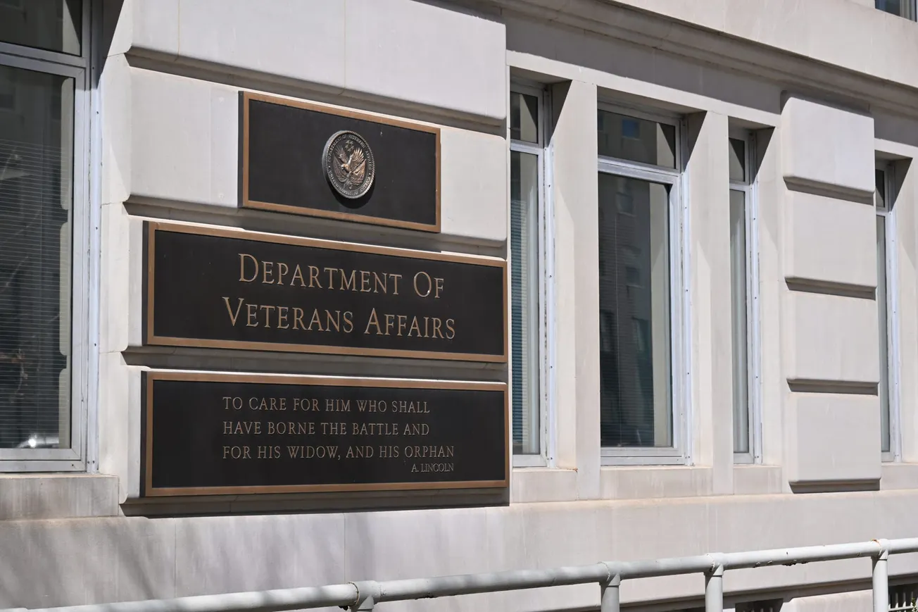 A photograph of the outside of the Veterans Affairs building, showing the sign that says "Department of Veterans Affairs."