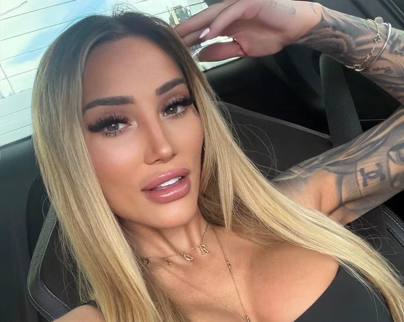 Caitlin Lyndon, a woman with long blonde hair, taking a selfie in a car