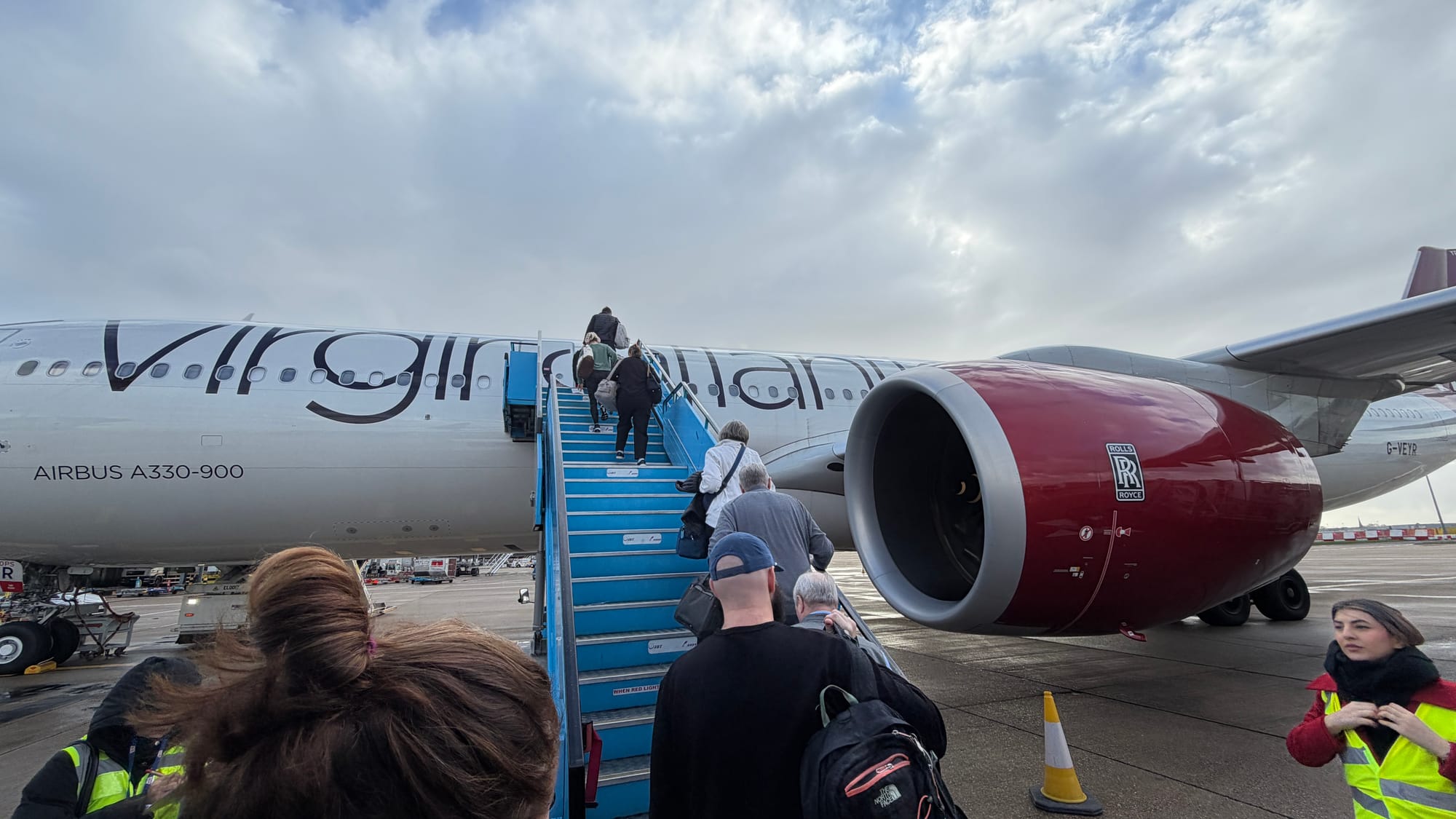 Passengers climbing stairs to board a Virgin Atlantic Airbus A330-900 on the tarmac at Heathrow